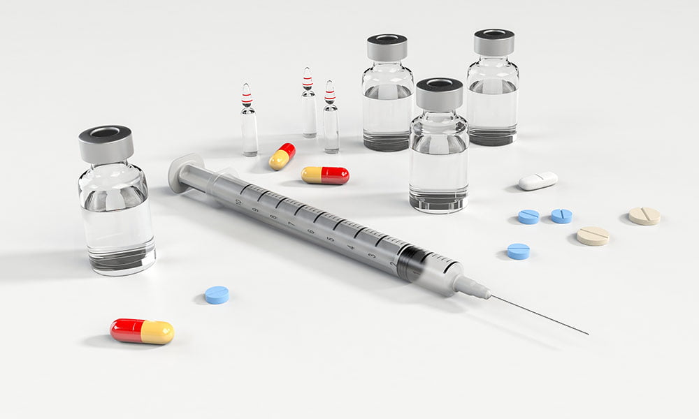 Photo of syringe and pills